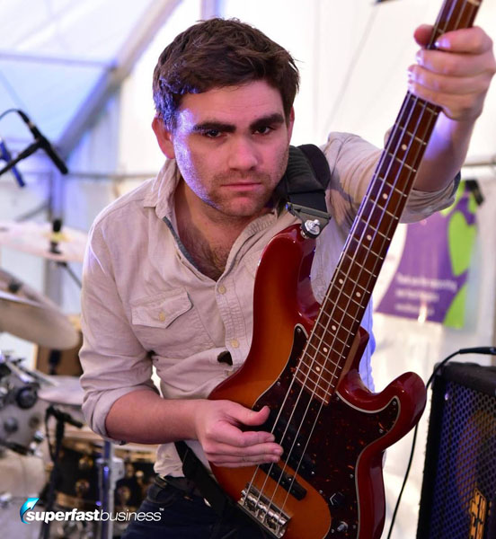 A Photo of James Eager holding a bass guitar